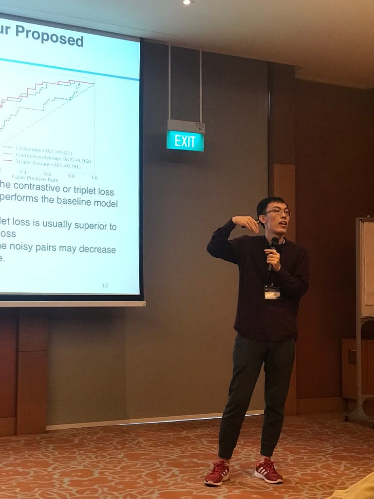 Me standing on stage at ICDM 2018 Singapore delivering the presentation of our AI research paper